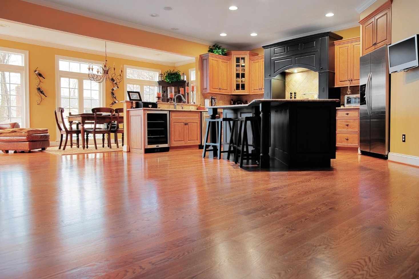 An overview shot of a stylish kitchen with wood flooring.