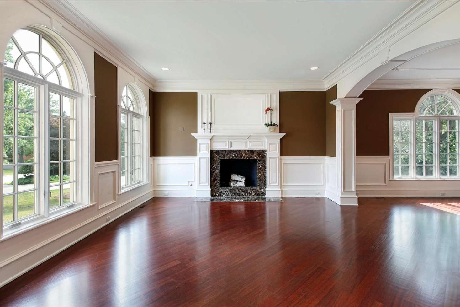Gorgeous sun-filled empty living room post img Gorgeous sun-filled empty living room showcasing freshly installed cherry hardwood floors